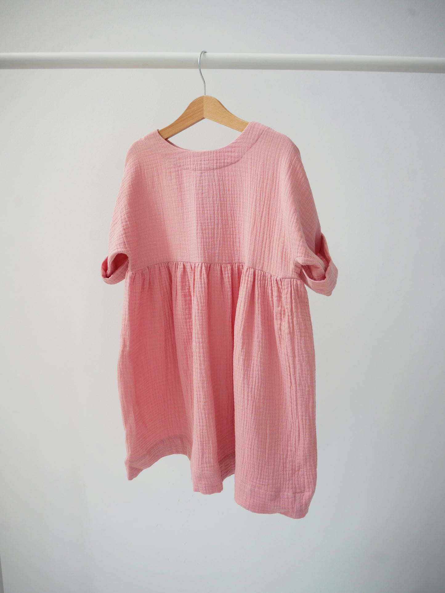 pale pink dress with buttons on the back