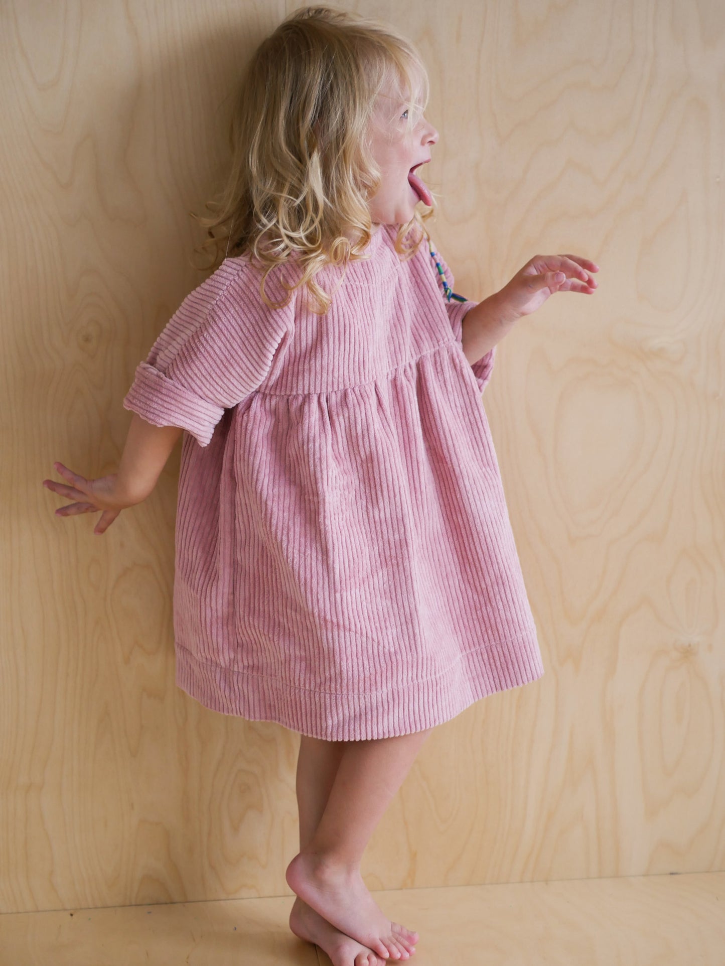 pink dress from corduroy with wooden buttons on the back