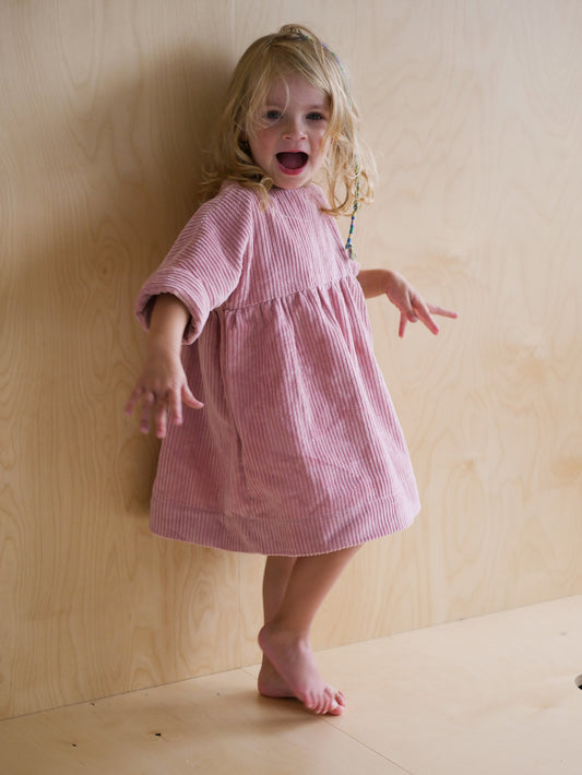 pink dress from corduroy with wooden buttons on the back