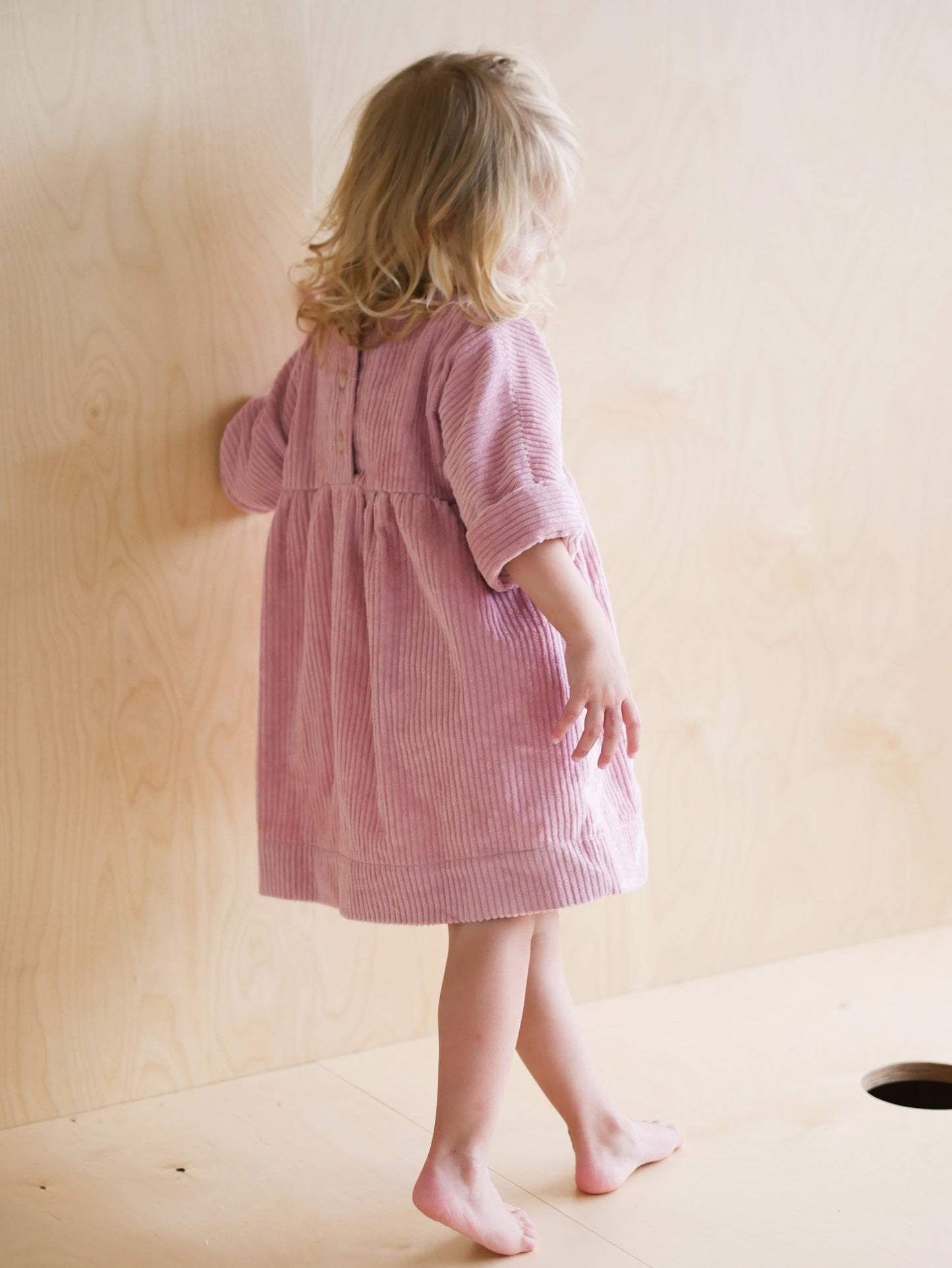 pink dress from corduroy with wooden buttons on the back
