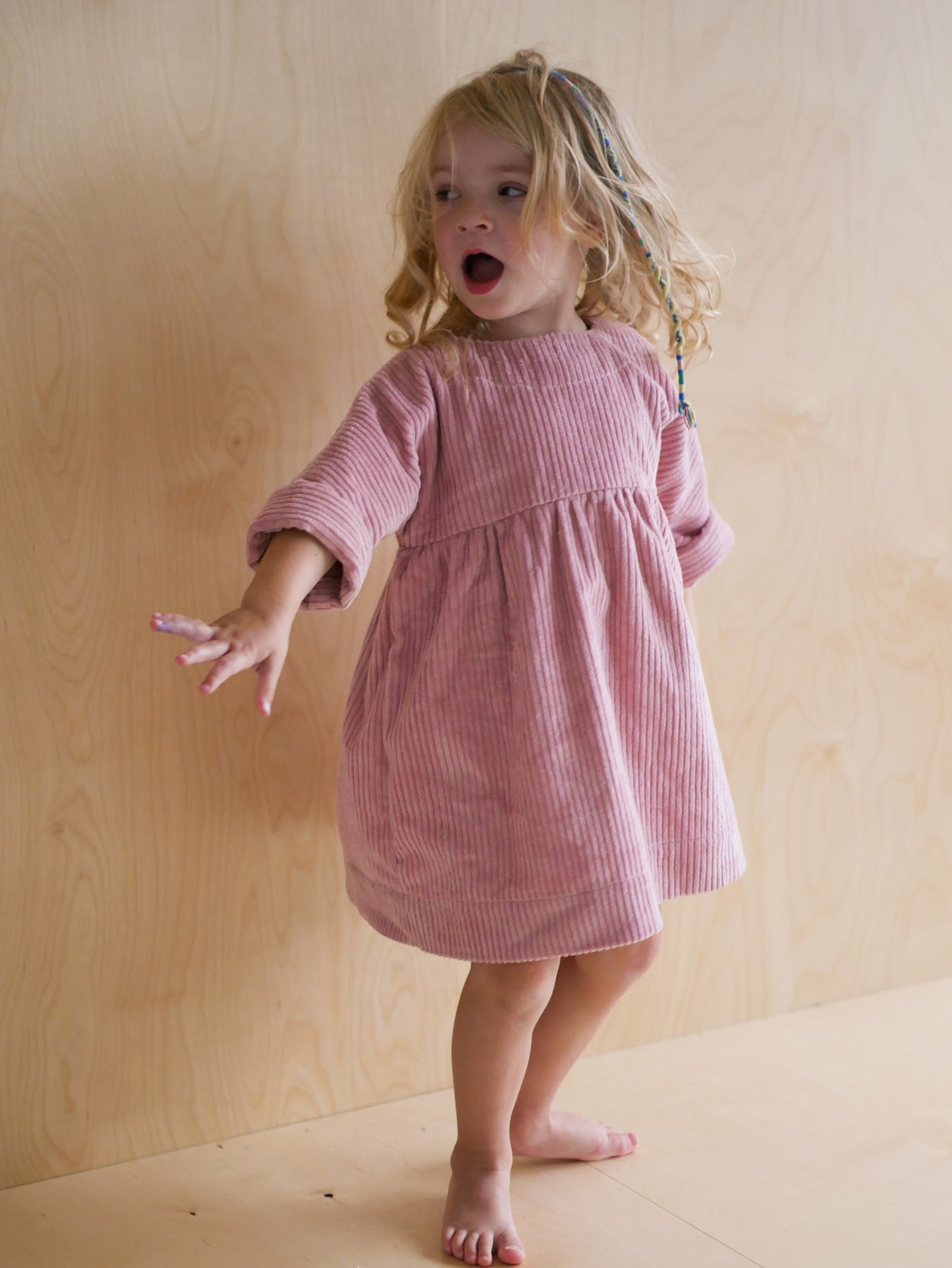 pink dress from corduroy with wooden buttons on the back