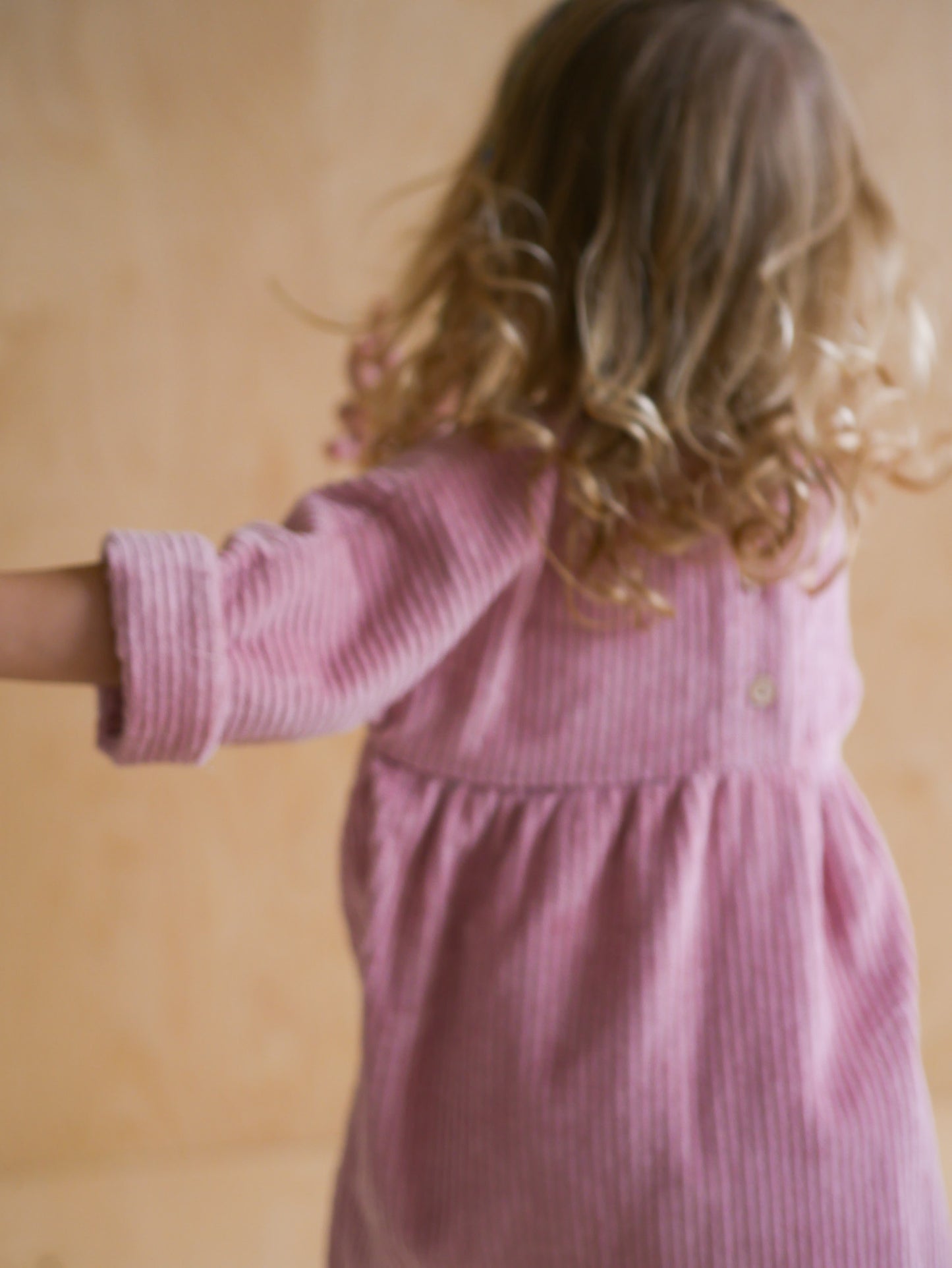 pink dress from corduroy with wooden buttons on the back