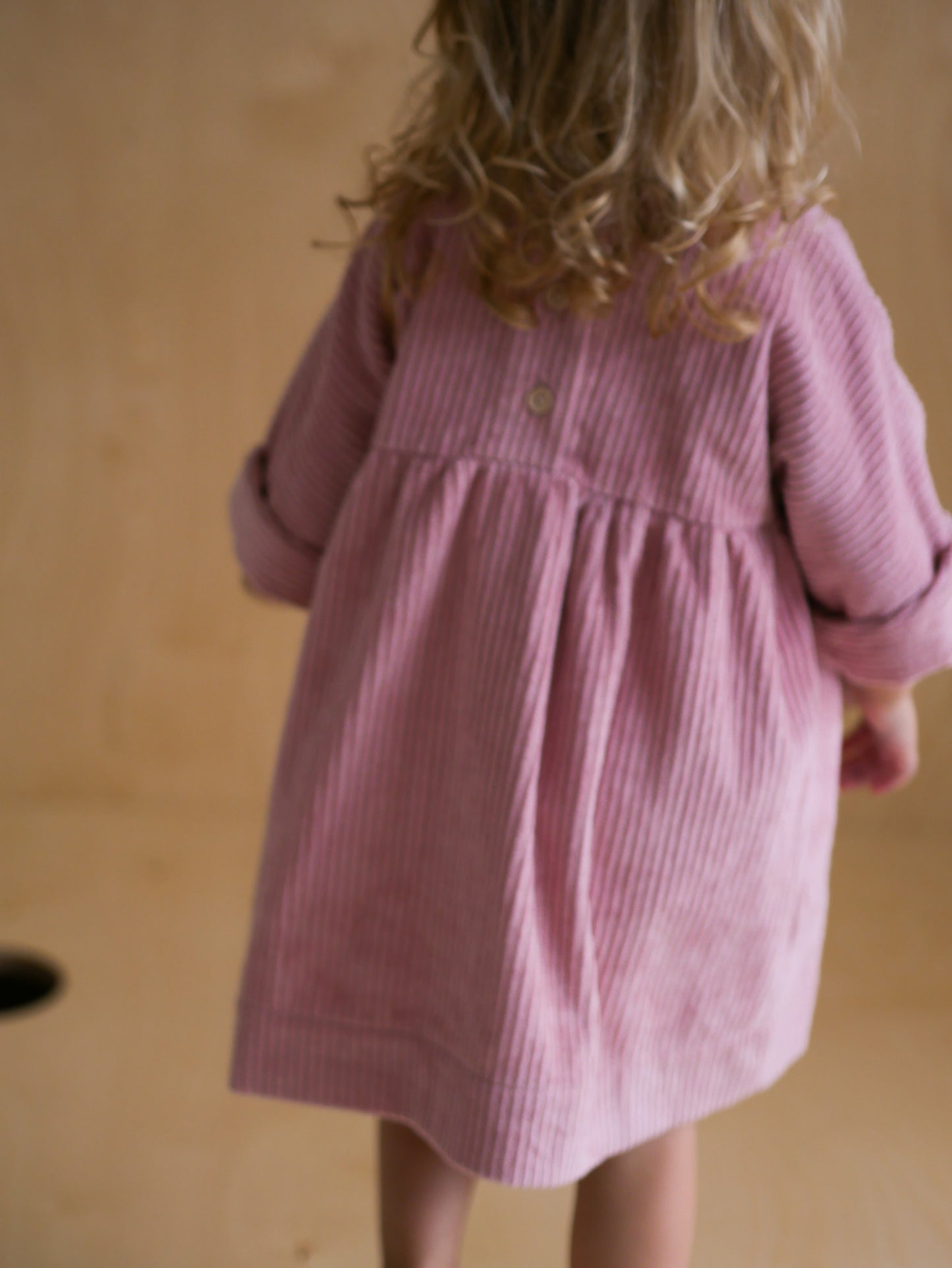pink dress from corduroy with wooden buttons on the back
