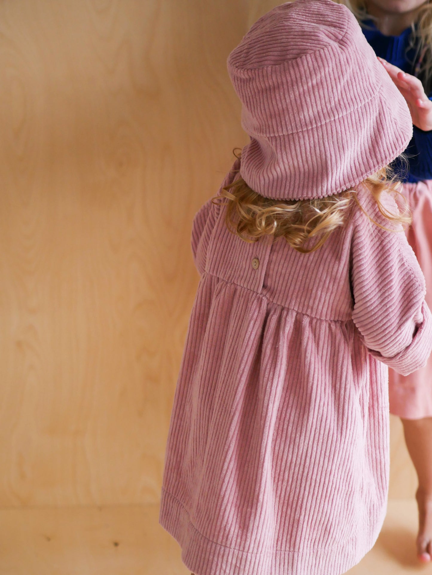 pink dress from corduroy with wooden buttons on the back