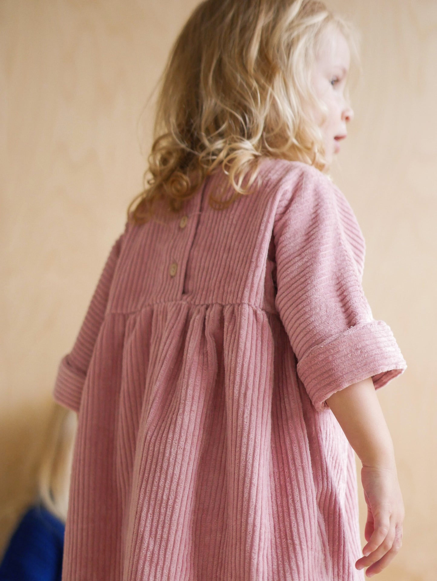 pink dress from corduroy with wooden buttons on the back