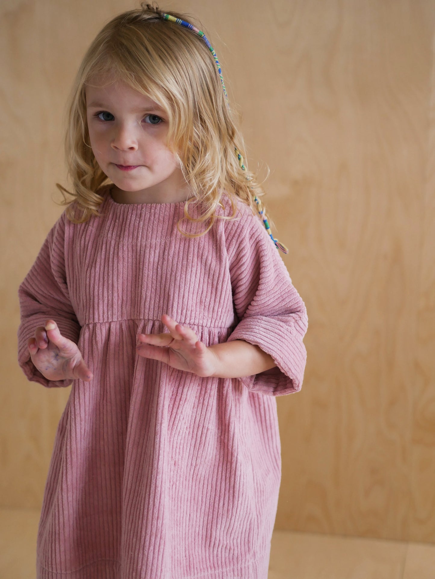 pink dress from corduroy with wooden buttons on the back