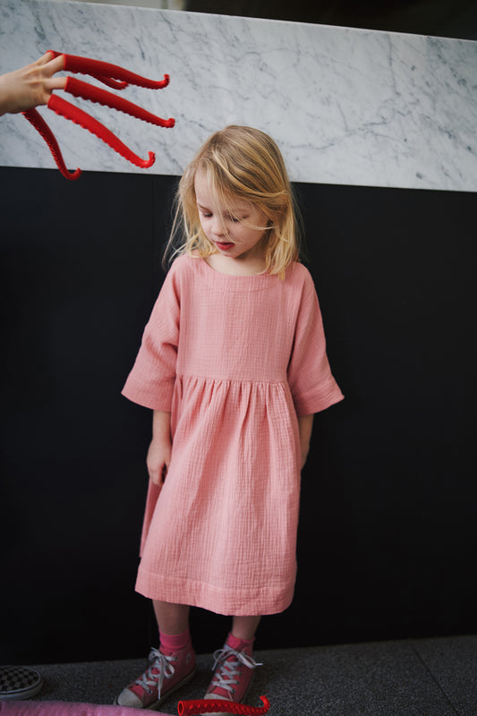 pale pink dress with buttons on the back